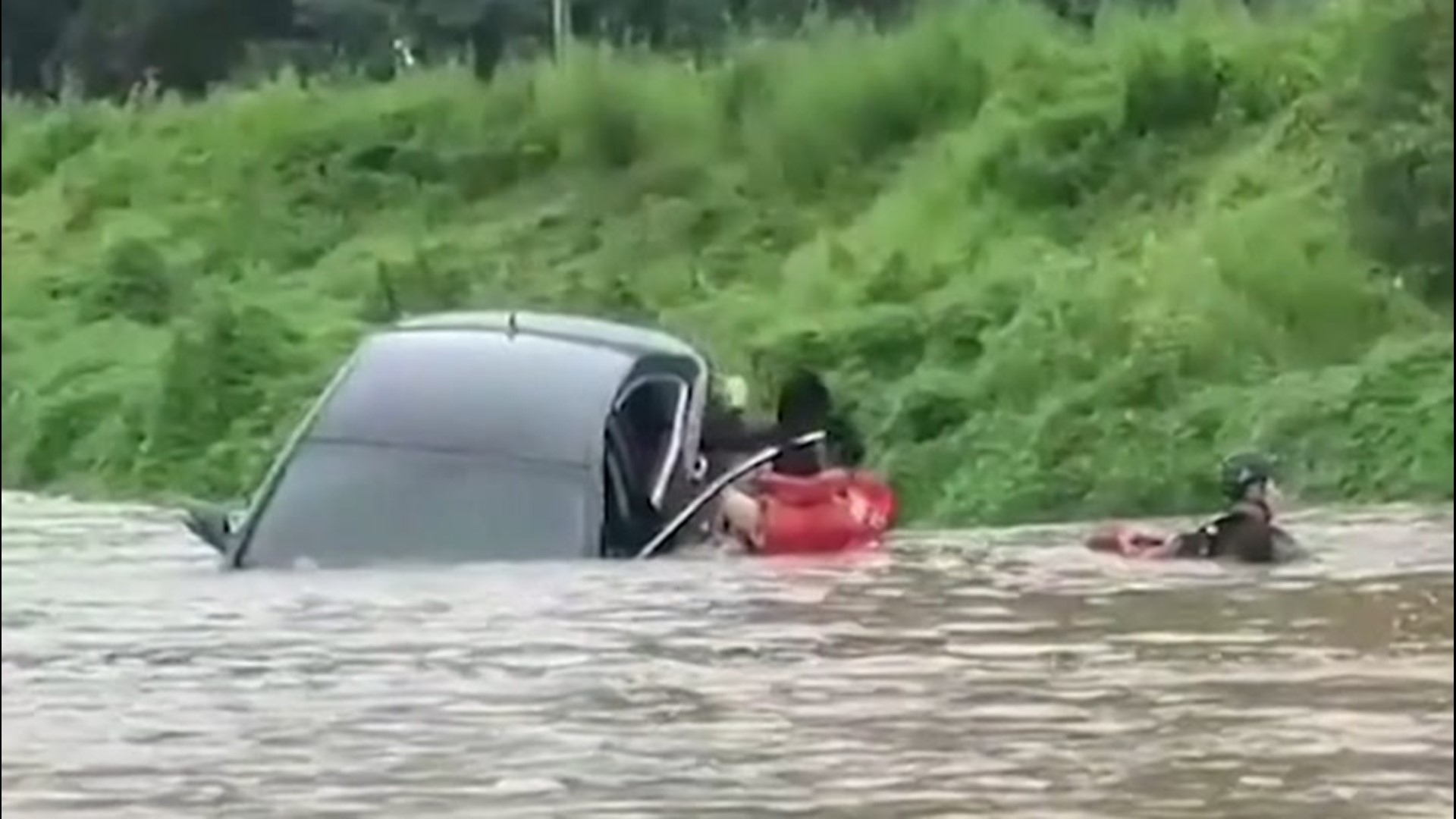 A woman in Cheongsong County, South Korea, was rescued on Aug. 8. Deadly flooding and a landslide caused more than 25 fatalities in the country.