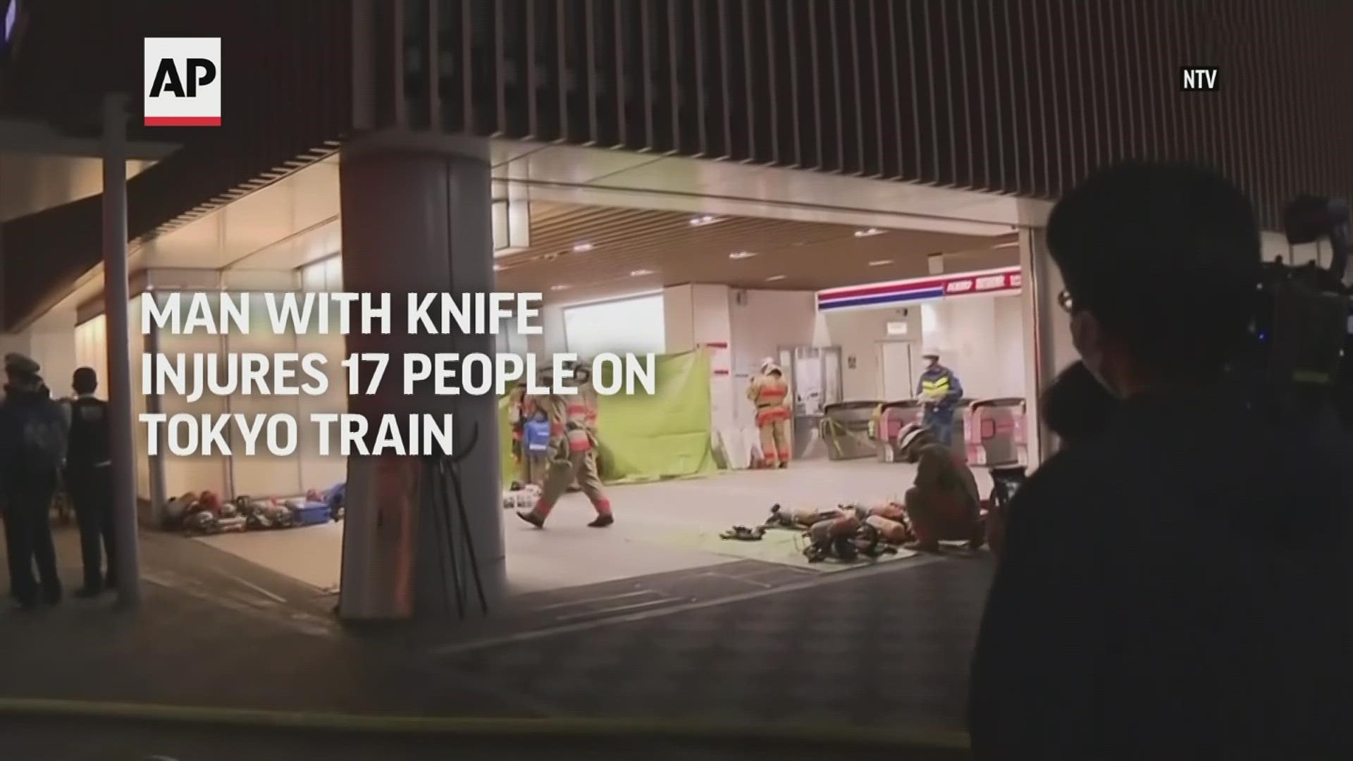 Police and witnesses in Japan say a man brandishing a knife on a Tokyo commuter train car stabbed several passengers before setting a fire.