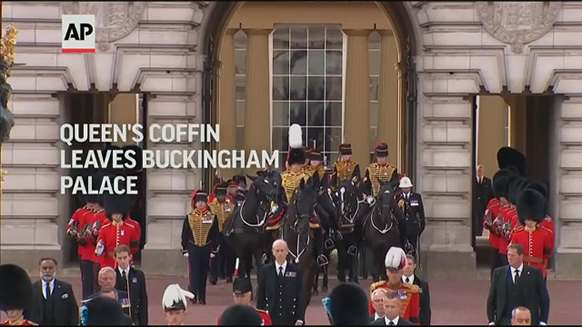 Queen Elizabeth II's coffin left Buckingham Palace for the last time Wednesday and was being taken amid somber pageantry on a horse-drawn gun carriage past crowds.