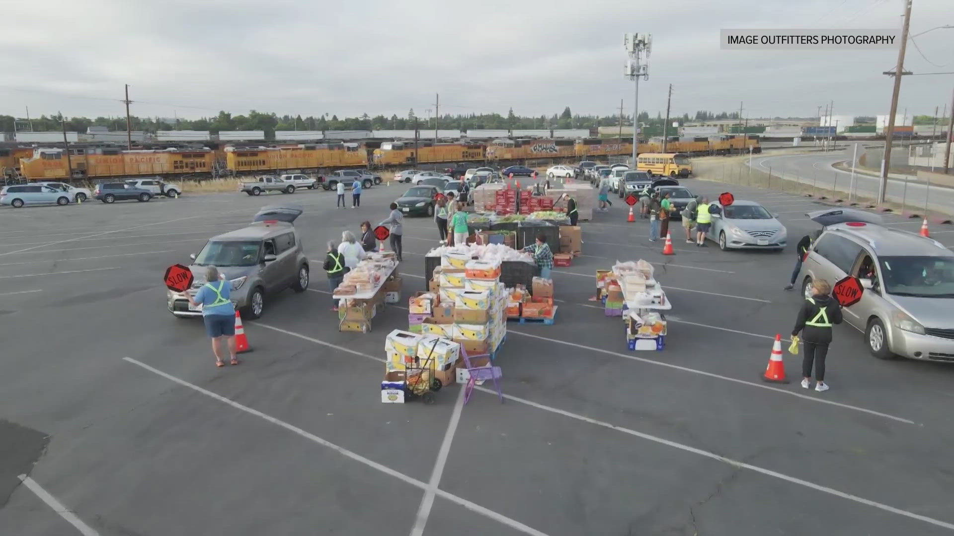 Mark S. Allen visits Denio's in Roseville, where cars line up for miles to receive free boxes of food. 