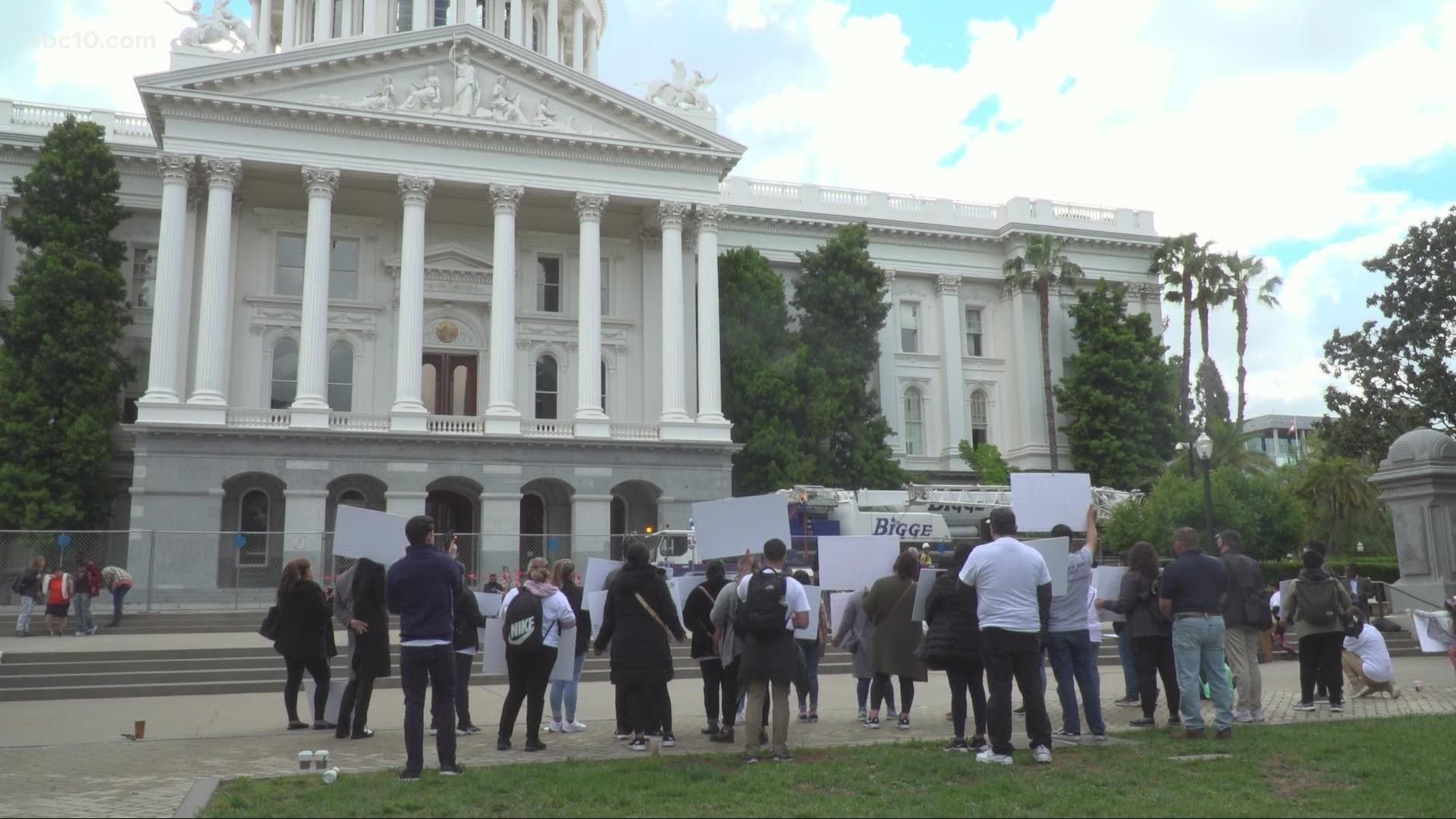 About a dozen people rallied in front of the California State Capitol Friday in Sacramento.