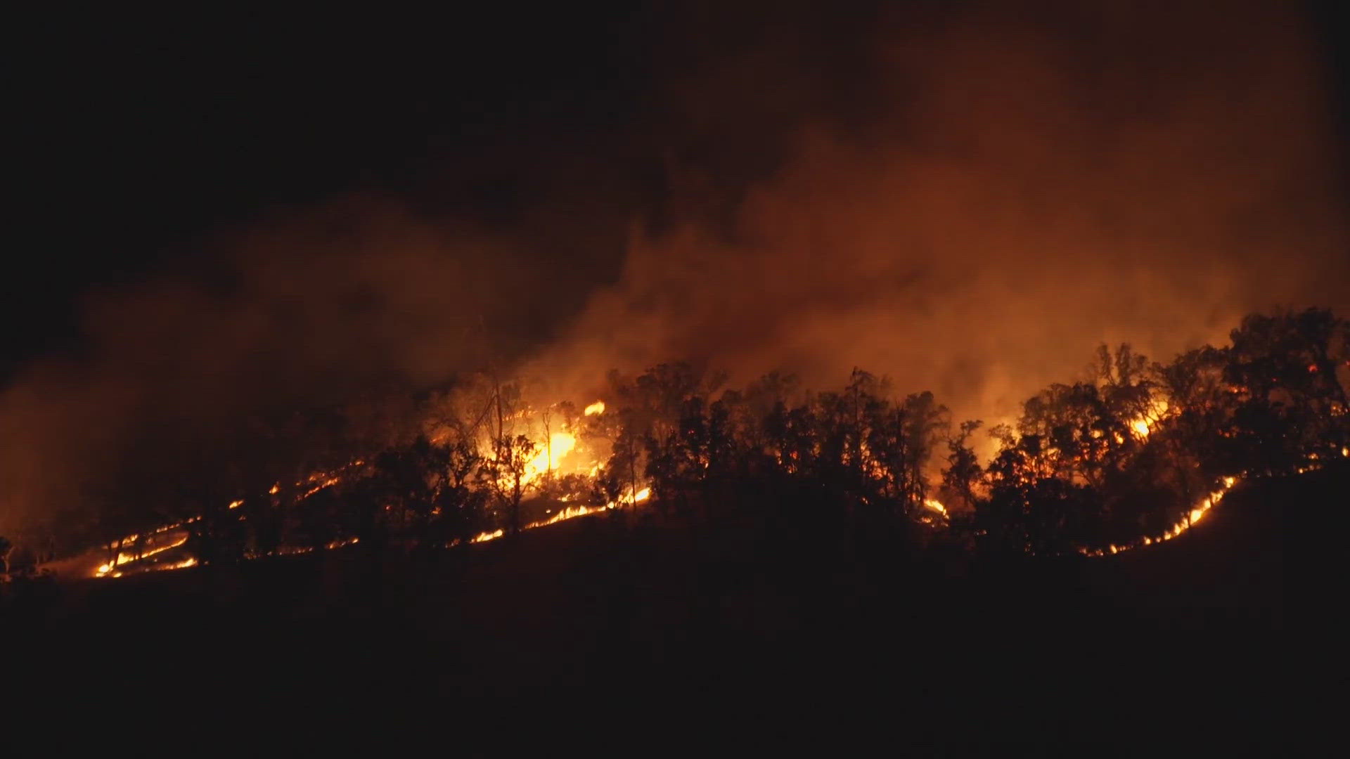 Cal Fire says roughly 50 structures are threatened by the rapidly spreading grass fire — 30 in Lake County and 20 in Colusa County.