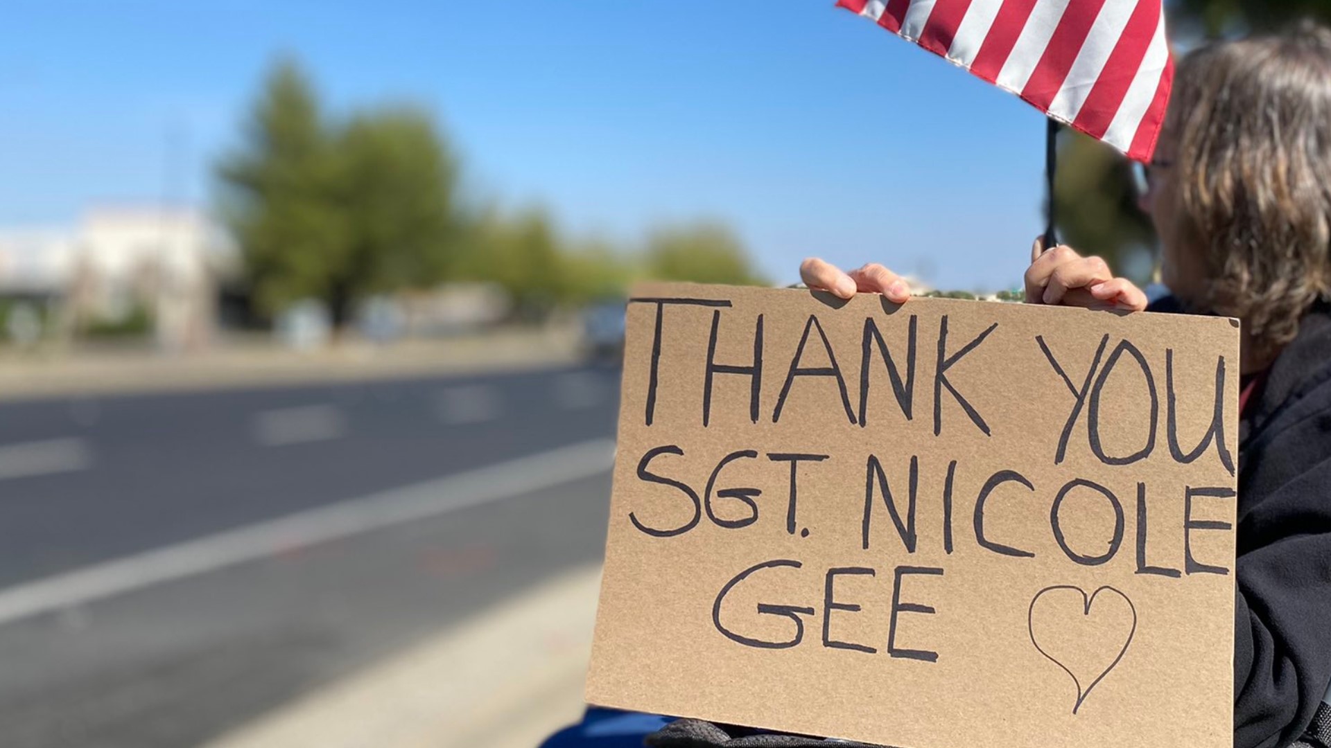 Dozens of community members from Roseville and beyond lined sidewalks holding American flags and signs to honor the service and sacrifice of USMC Sgt. Nicole Gee.