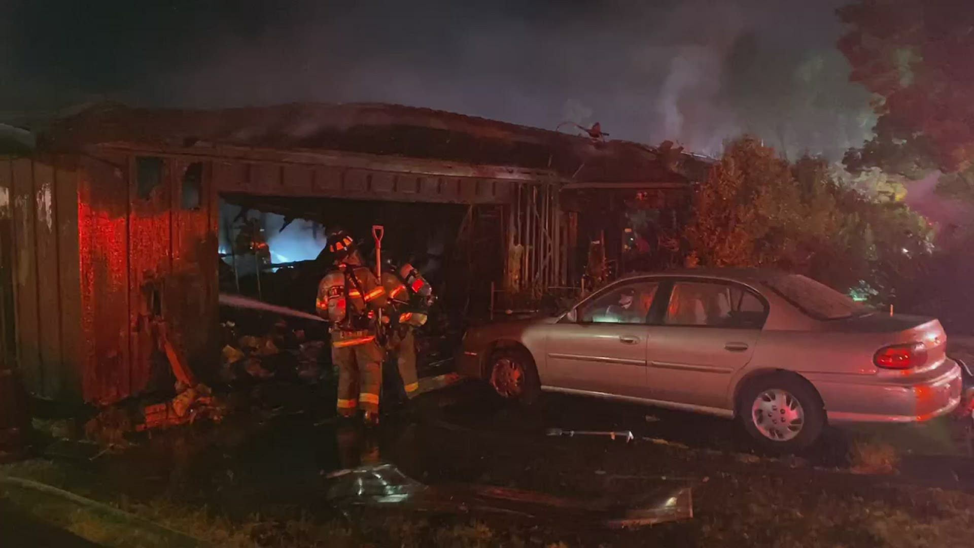 Fire crews continued to spray the smoldering remains of a garage early Monday morning.