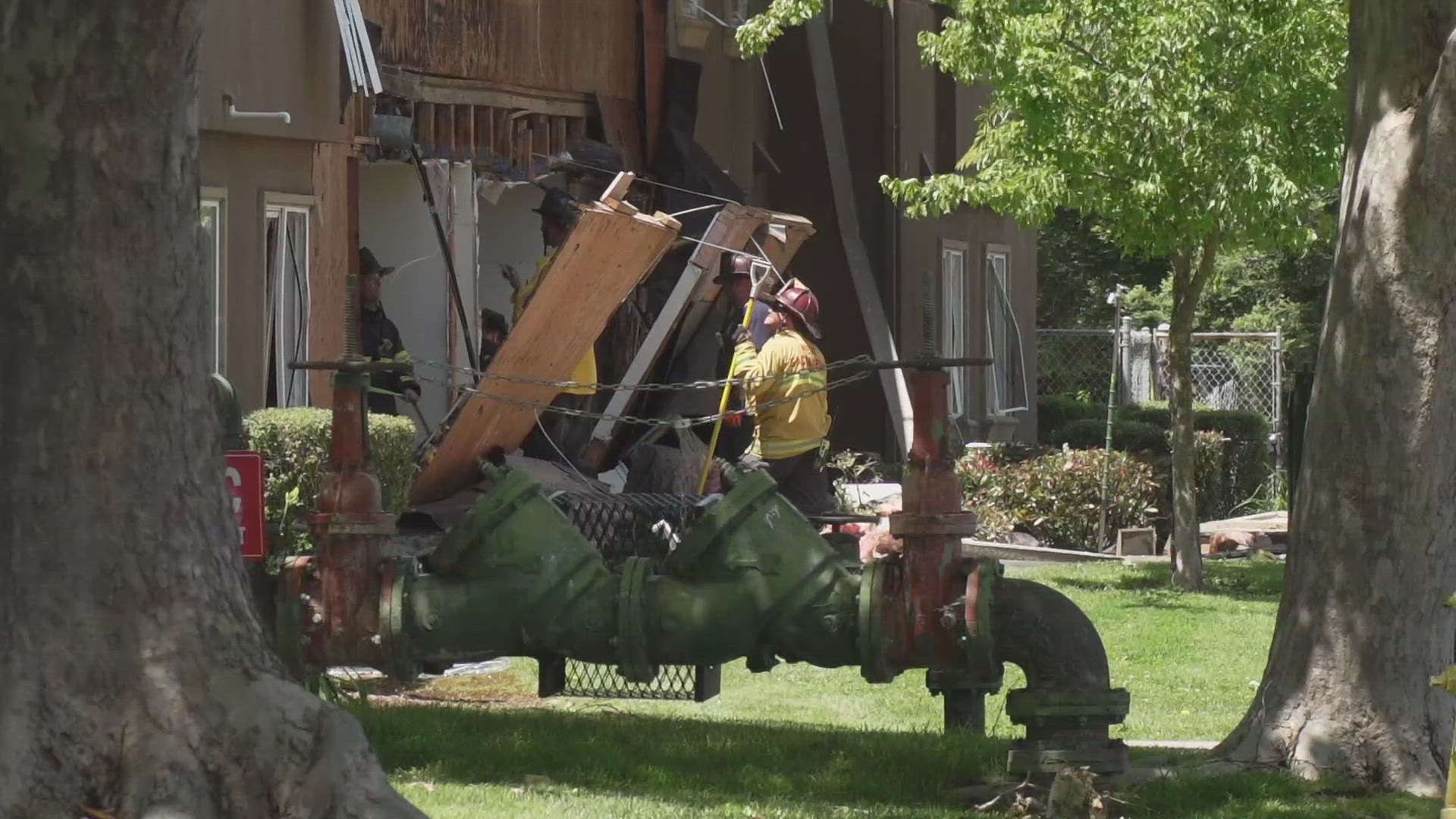 The West Sacramento Fire Department said it is still looking into what caused the explosion at Washington Courtyard apartments that injured two people.