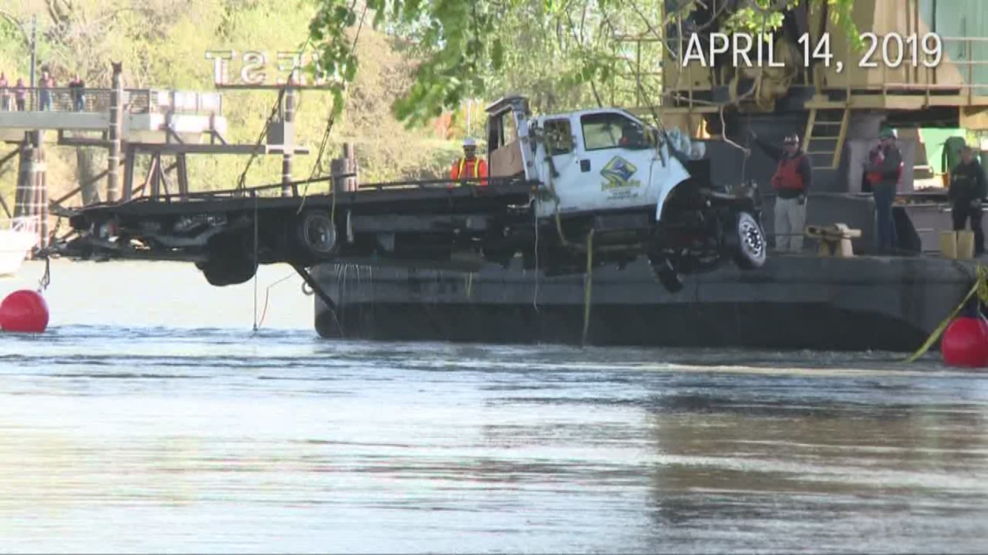 Nineteen days after a big-rig collided with a tow-truck, throwing it and two passengers into the Sacramento river, a private dive team and crew has pulled it from the water.