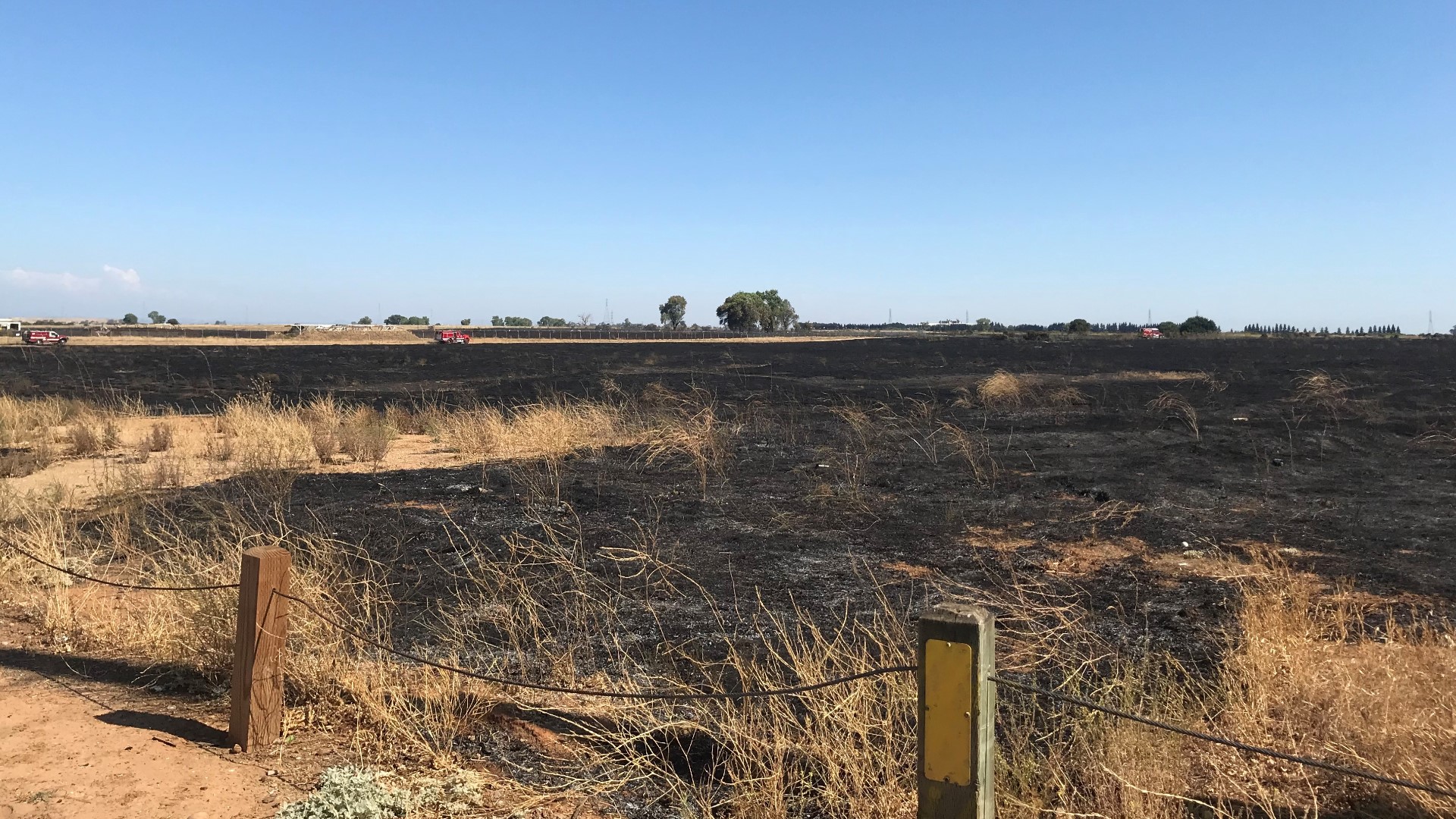 The grass that's being burned has been in the sun and has dried out a lot. Fire crews burn them before fire season so they can't be used as fuel for a wildfire.