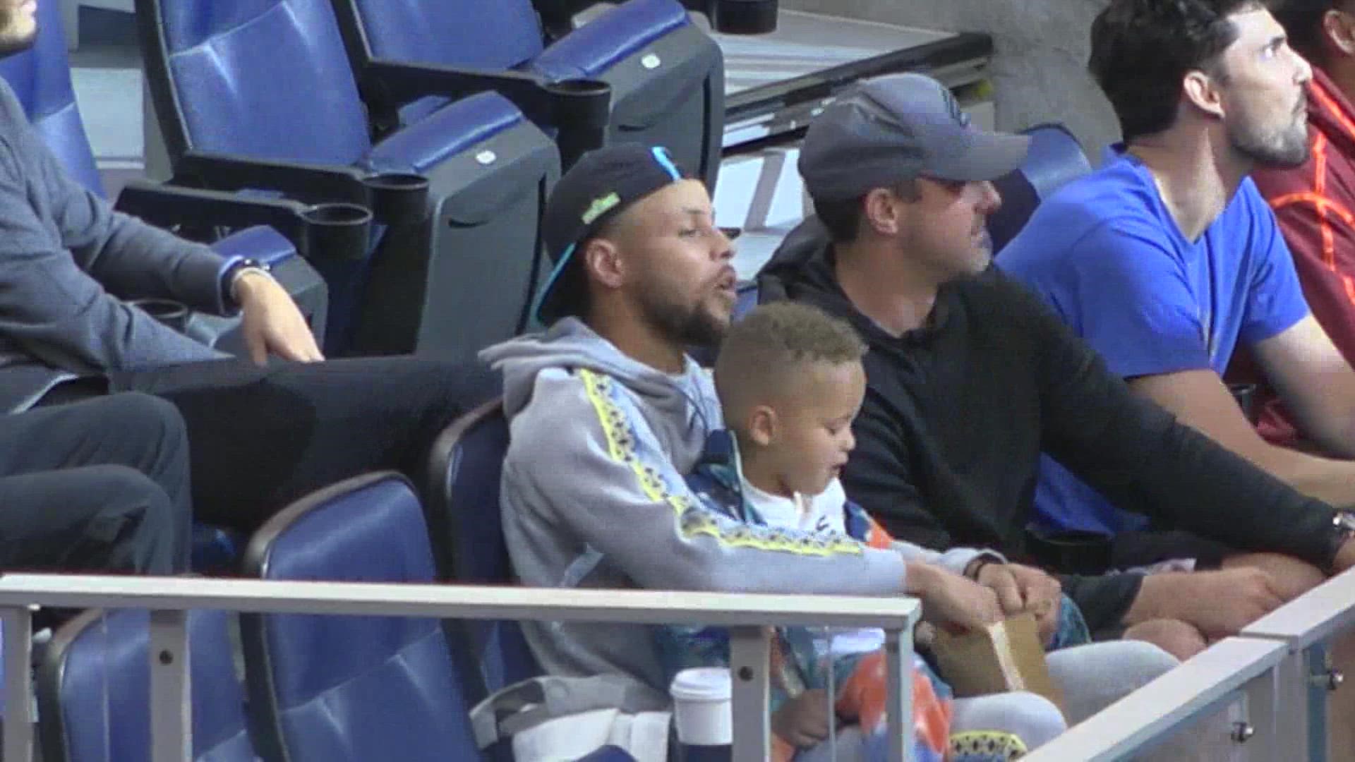 Steph Curry at the Warriors vs Kings game Saturday, sitting in the crowd with his son. He even gets his son to toss a shirt into the fans.
