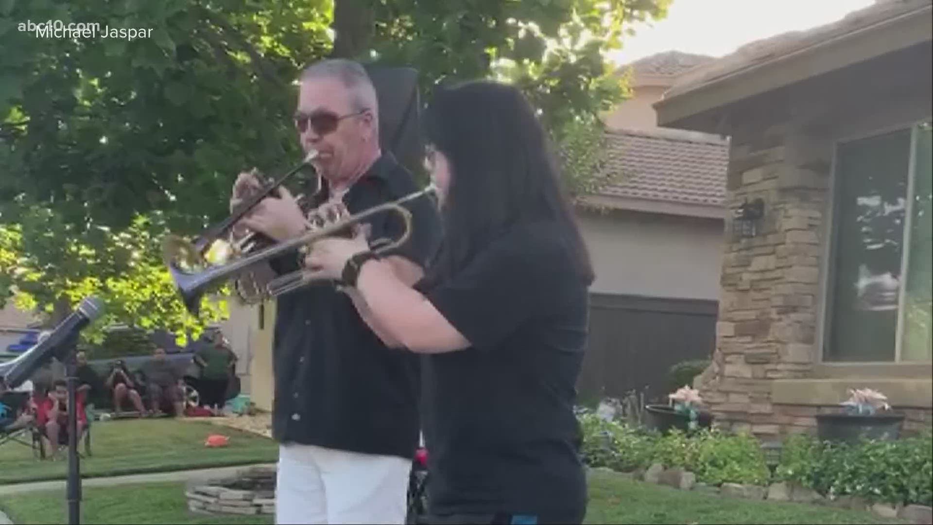 Michael Jaspar and his daughter played for their neighbors in Rancho Cordova while everyone practiced social distancing.