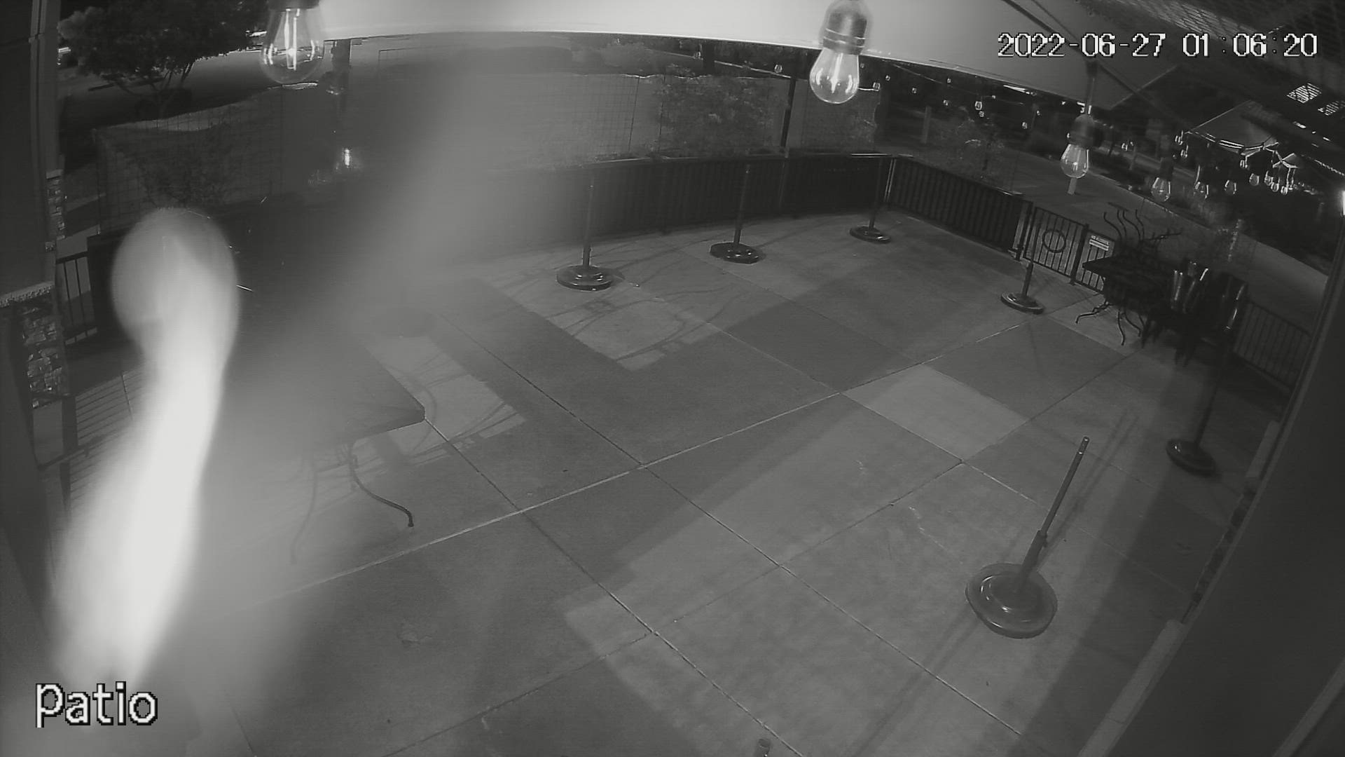 Security footage from Flour Dust Pizza Company shows a person walking around the outdoor patio and in front of the restaurant smashing windows.