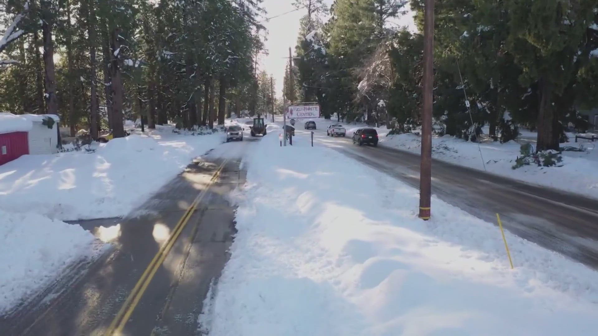 Heavy rain flooded California roadways and much-needed snow piled up in the mountains as the first of back-to-back atmospheric rivers pummeled the state.