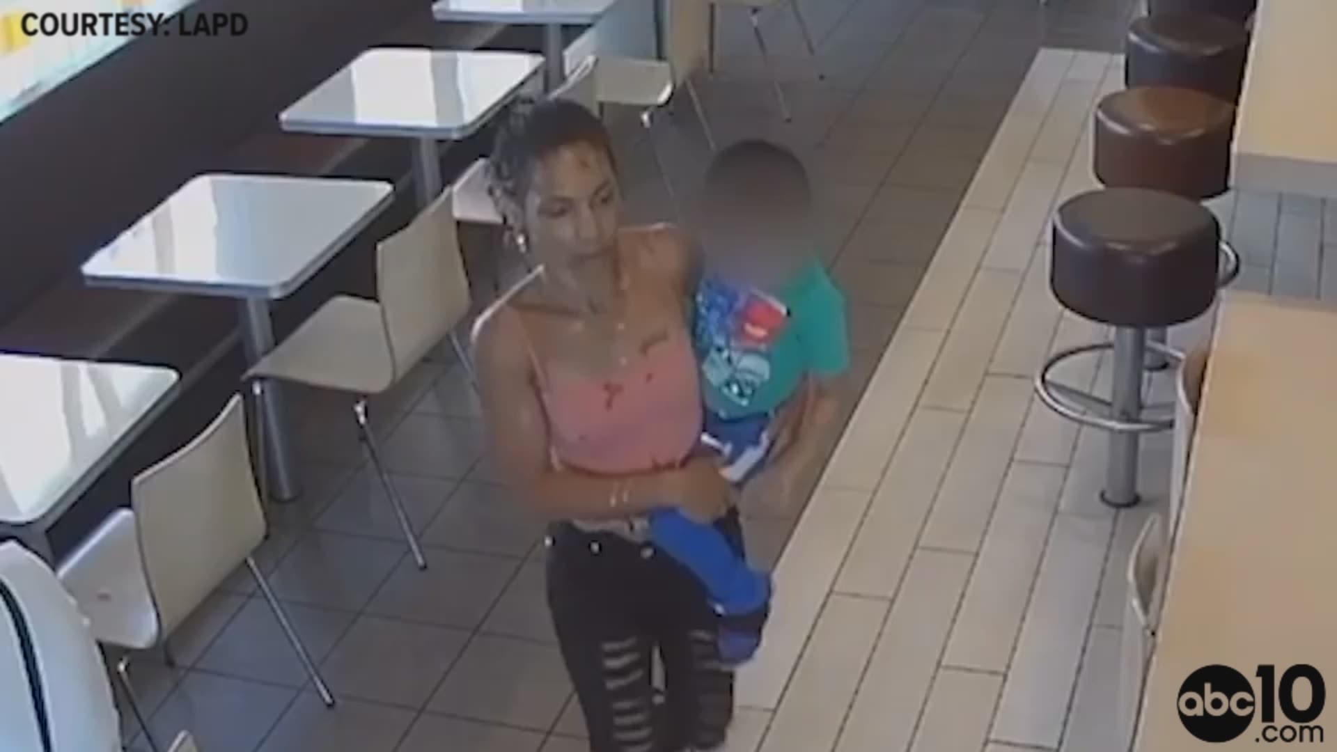Surveillance cameras show the woman pick up the boy and carry him outside. She then tried to get into a parked car but a witness stopped her and she ran off.