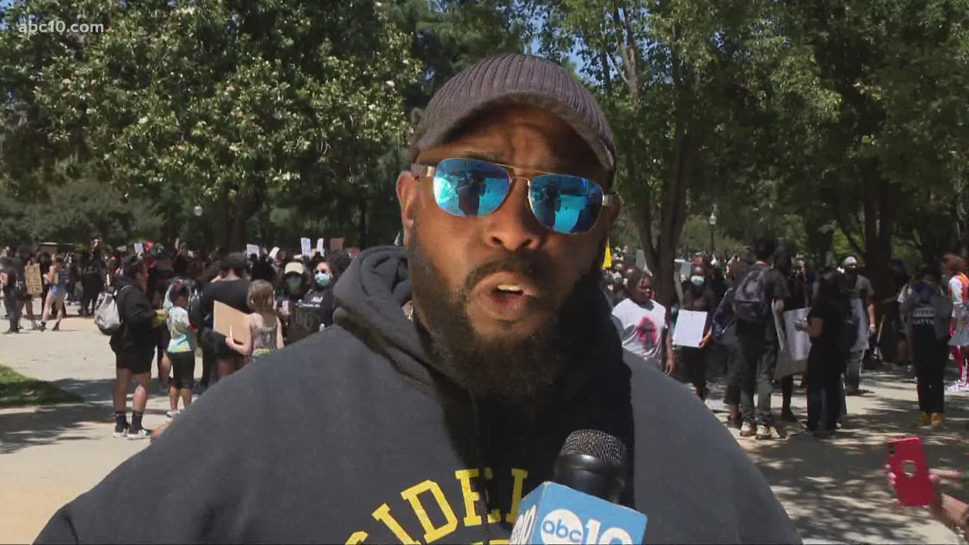 Actor Christopher Michael Holley talks with Mark S. Allen at the Sacramento Peace March about the need for change, saying, "this is just the beginning."