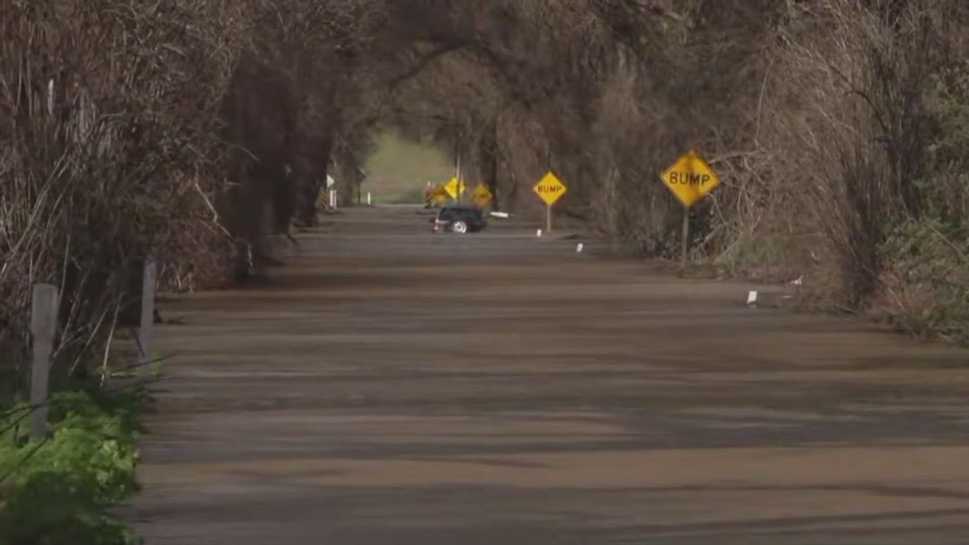 Fire crews rescued two people trapped on top of their vehicle in standing water in Sacramento County Monday morning.