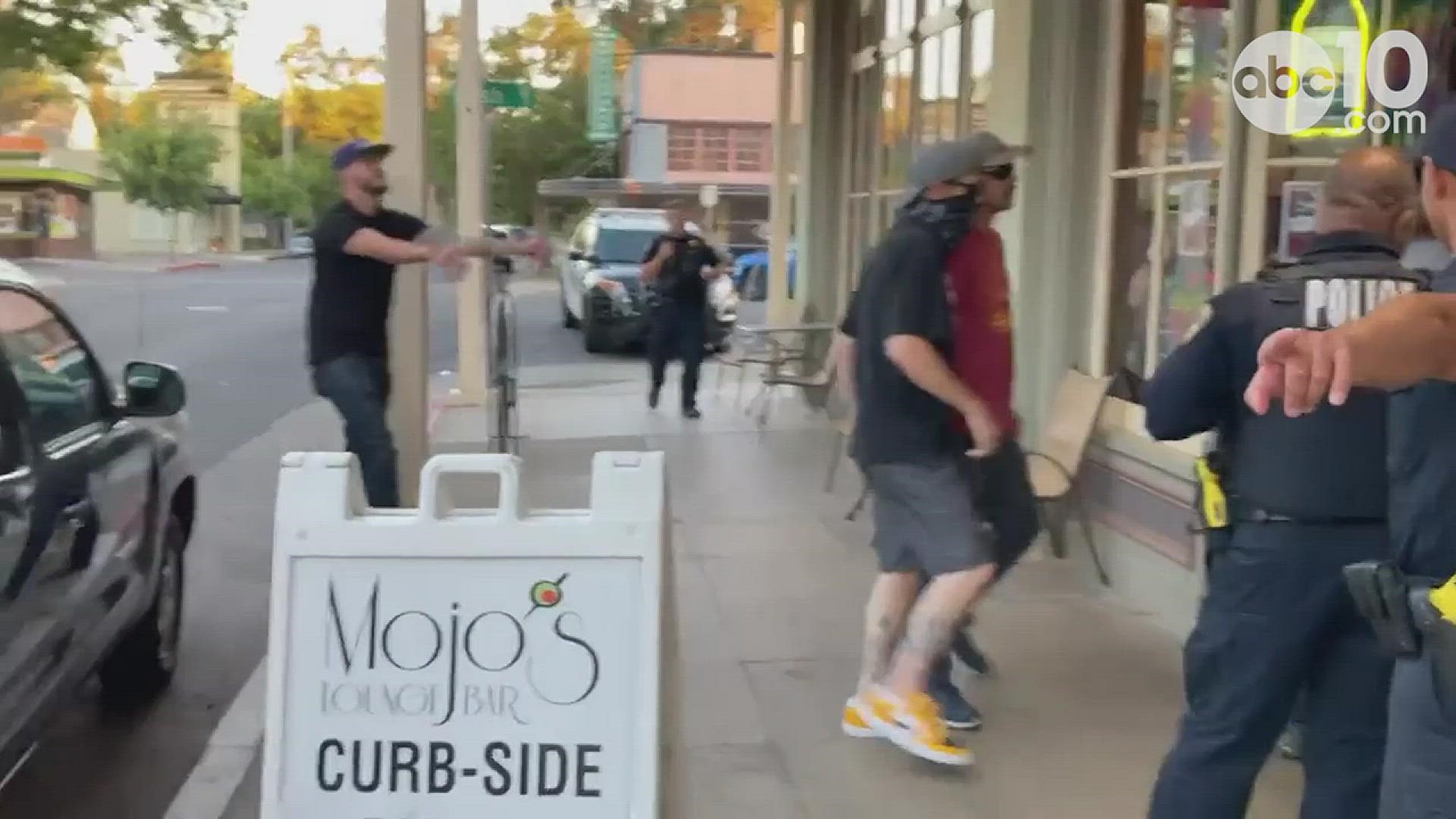After a Woodland bar canceled a "Drag Queen Happy Hour" event due to what they said were threats of violence, video shows a group of people clashing with others.