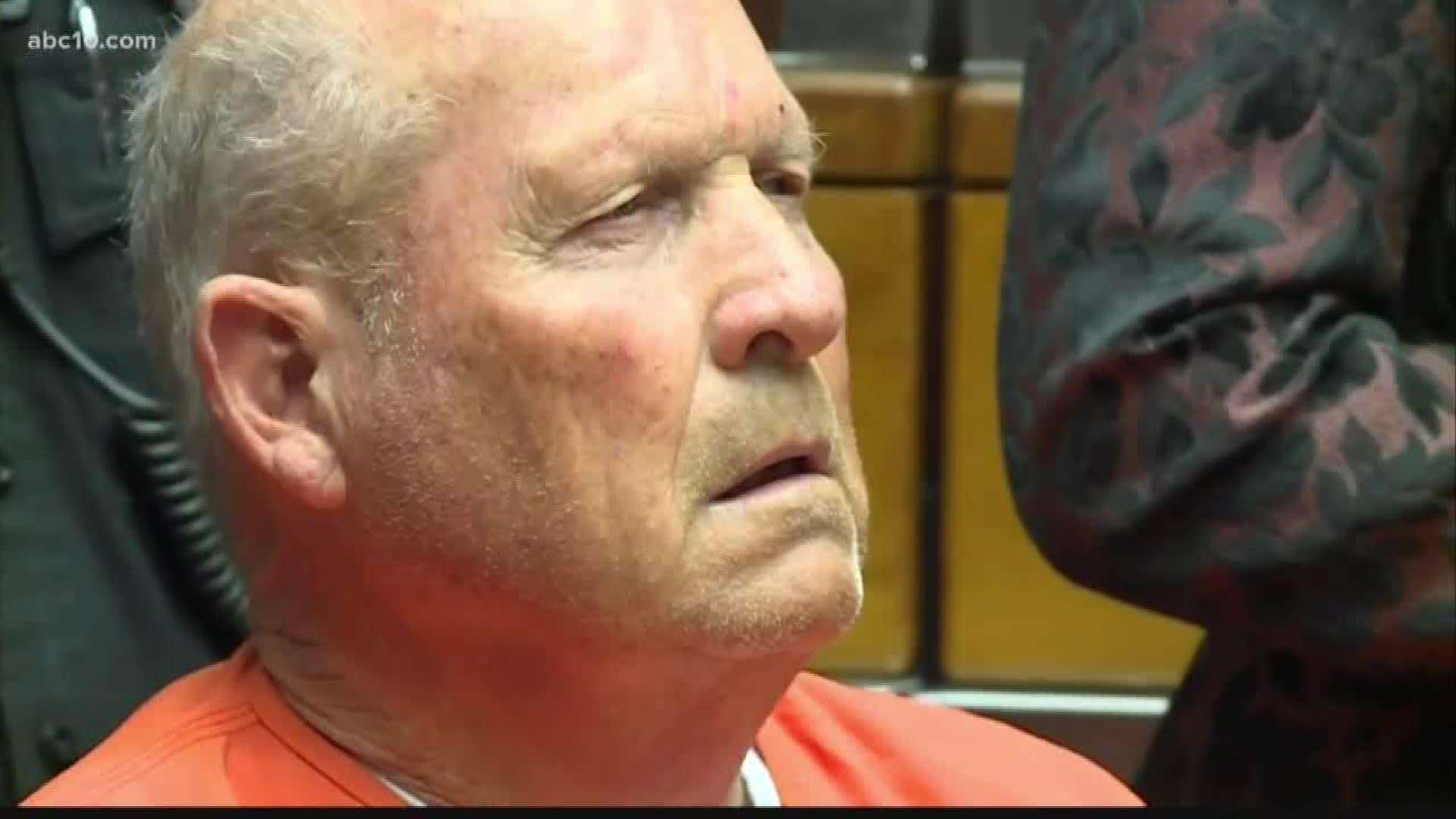 A 72-year-old former police officer accused of being one of California's most elusive serial killers appeared in a courtroom cage used for defendants in jail Monday as a judge put off a decision on whether to release search and arrest warrants in the case
