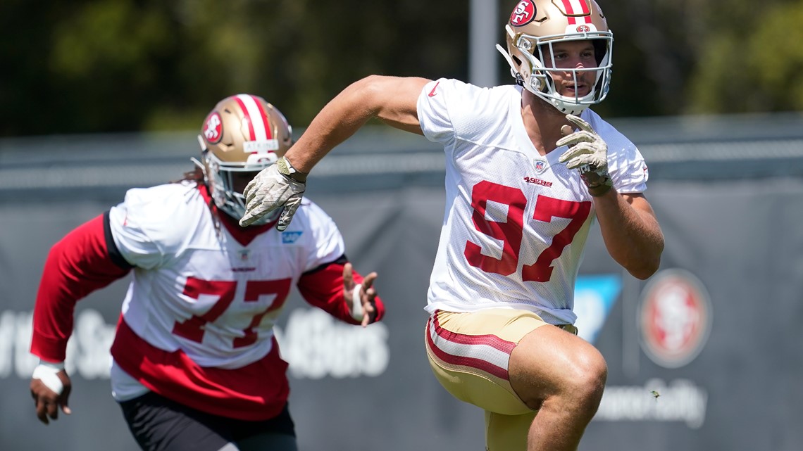 San Francisco 49ers first-round pick Nick Bosa, center, holds up a jersey  next to his mother Cheryl, left, and father John during an NFL football  news conference, Friday, April 26, 2019, in