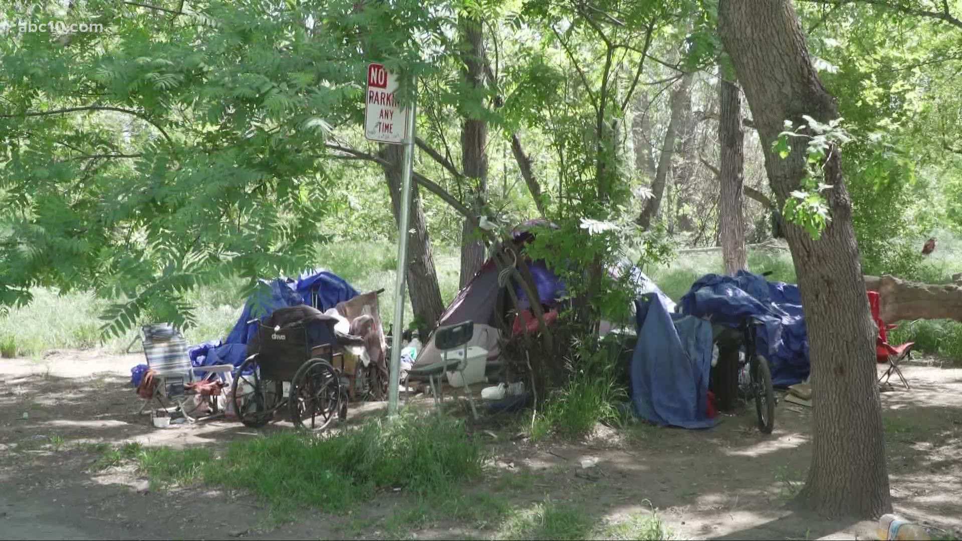 After a woman was found dead near the bike trail, people living in the nearby encampment feel less safe, hoping the same thing doesn't happen to them.