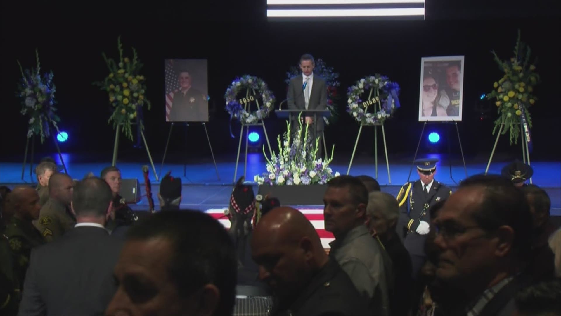 A pastor reads the words written by the wife of fallen El Dorado County Sheriff's Deputy Brian Ishmael at his memorial service.