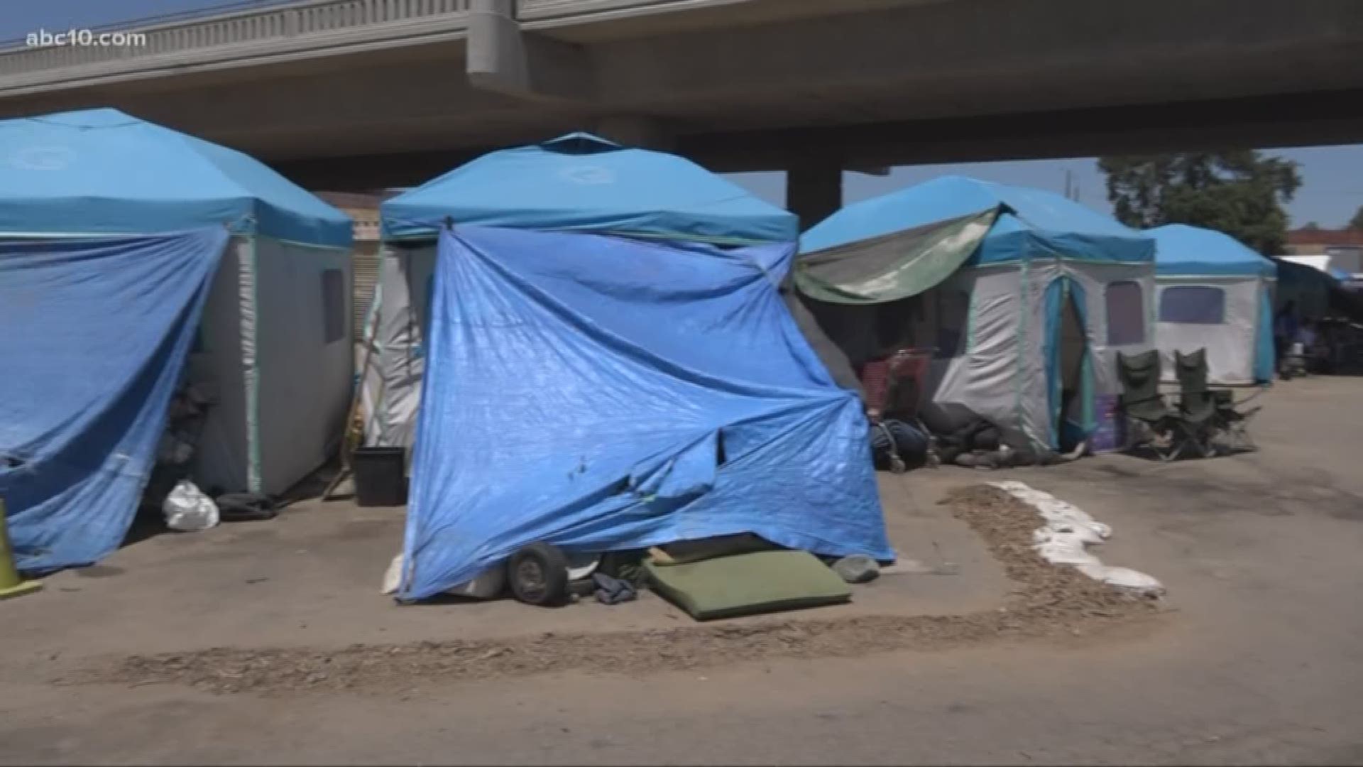 People living in tents at the Modesto Outdoor Shelter try to stay cool and hydrated in triple digit heat.