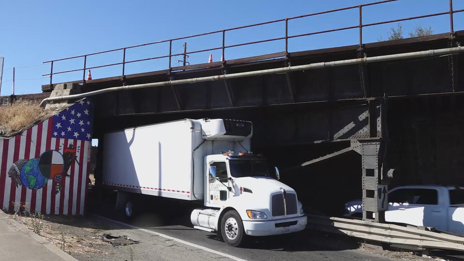 The current clearance causes issues for larger trucks and it's a tight squeeze.