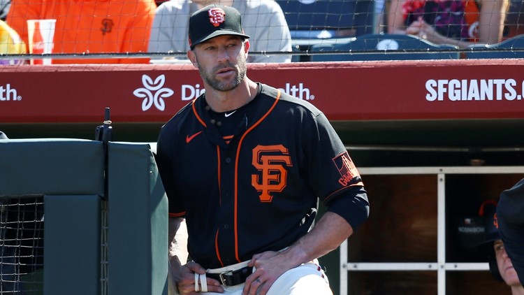 Giants manager Gabe Kapler stands on the field for national anthem