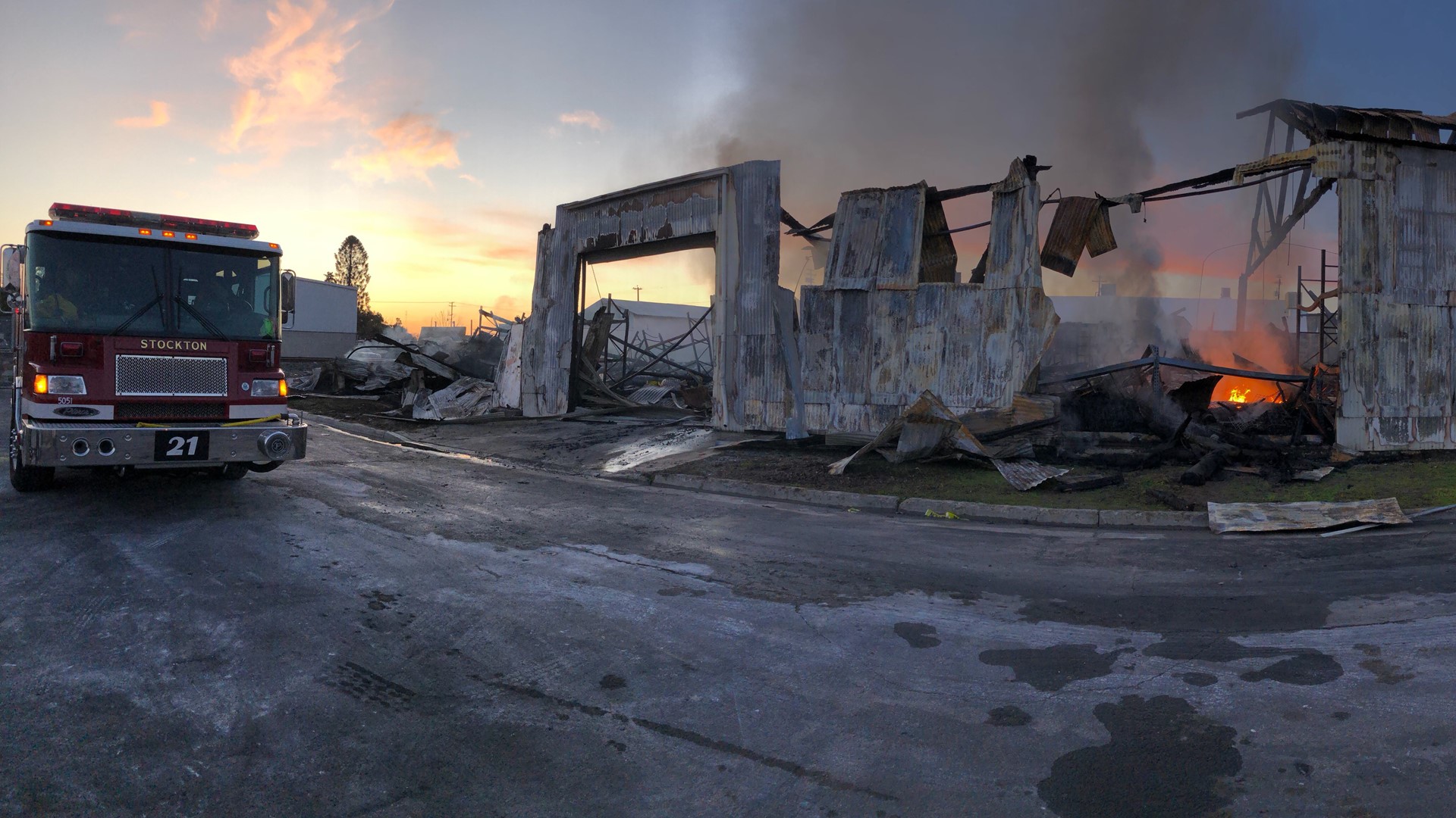 Fires were still smoldering Friday morning from a blaze that destroyed three warehouses in Stockton.