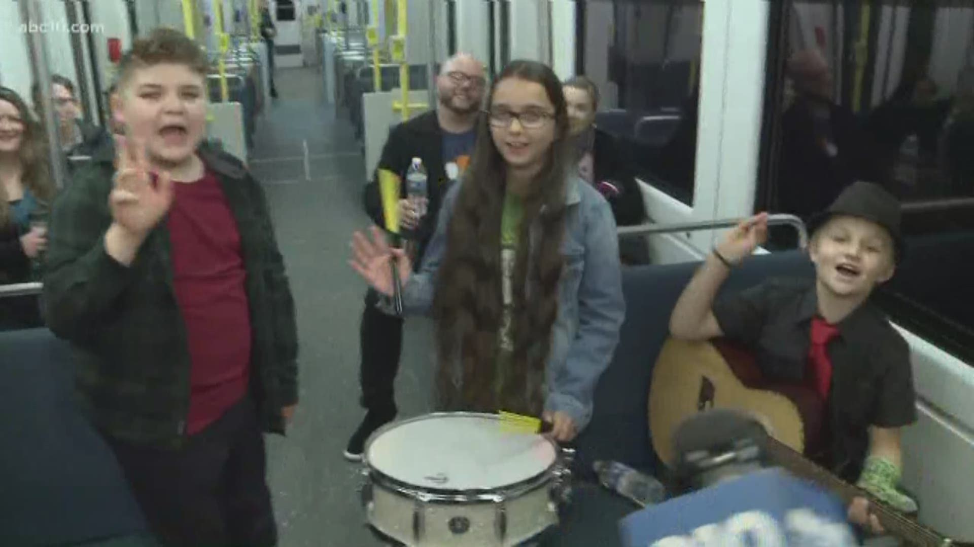 Mark S. Allen is doing Mark S. Allen things on a light rail with The Rockstar Kids Band.
