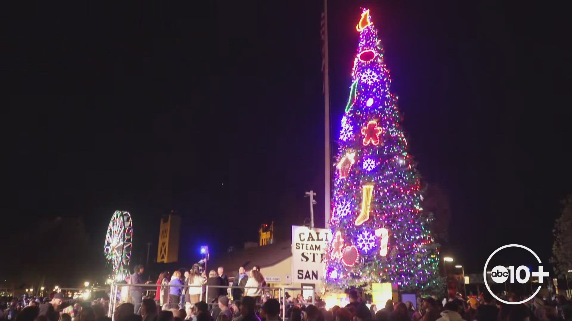 Dozens flock to Old Sacramento to watch the lighting of the 60-foot holiday tree.