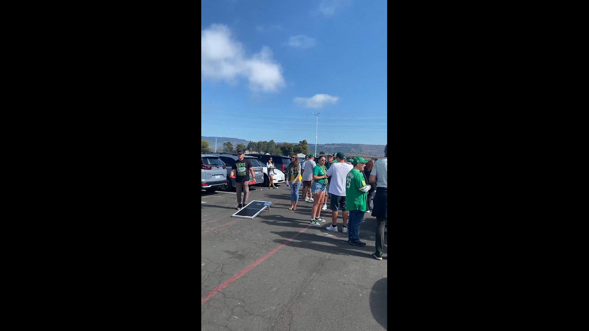 A's fans tailgate outside of the Oakland Coliseum ahead of the team's final home game at the venue.