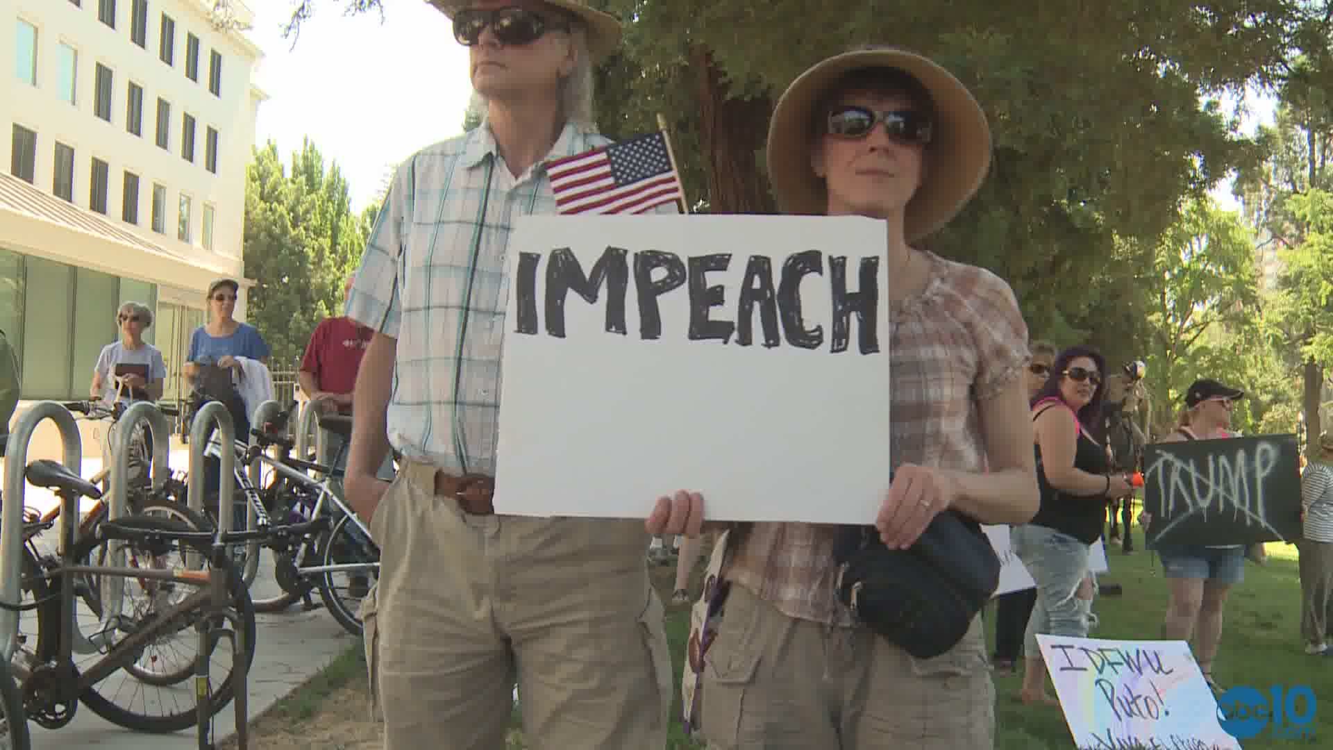 Impeachment demonstrators, hoisting signs and chanting anti-Donald Trump slogans, marched through dozens of cities on Sunday (July 2, 2017)