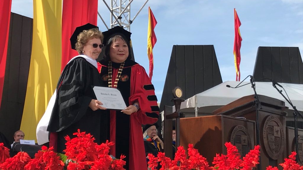 Dorothy Bizzini has shown up to every graduation, except for one, since the university was established in 1965. This year, however, she was on the receiving end of an honorary degree.