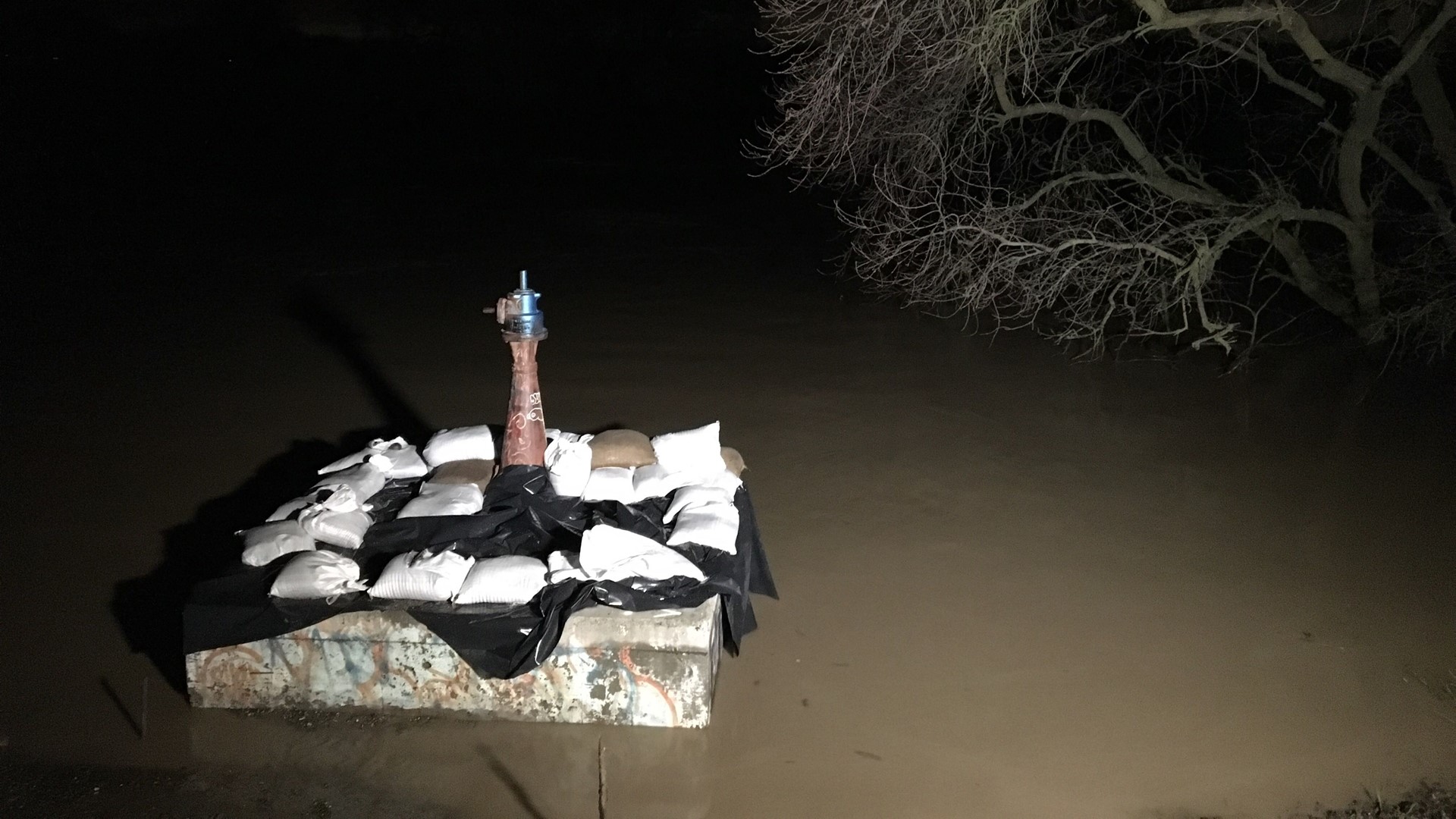 Cache Creek, normally fairly calm and meandering, right now is swollen and angry here in Yolo County, as heavy rains have caused it to swell and, about 2 miles away from here, actually overtop its banks.