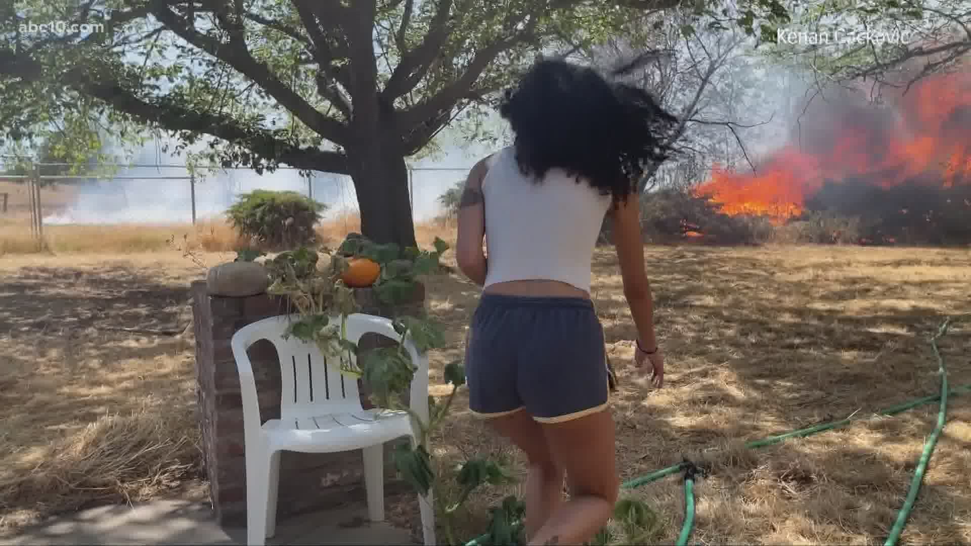 A real estate photographer when he captured firefighters arriving at a home threatened by a nearby vegetation fire.