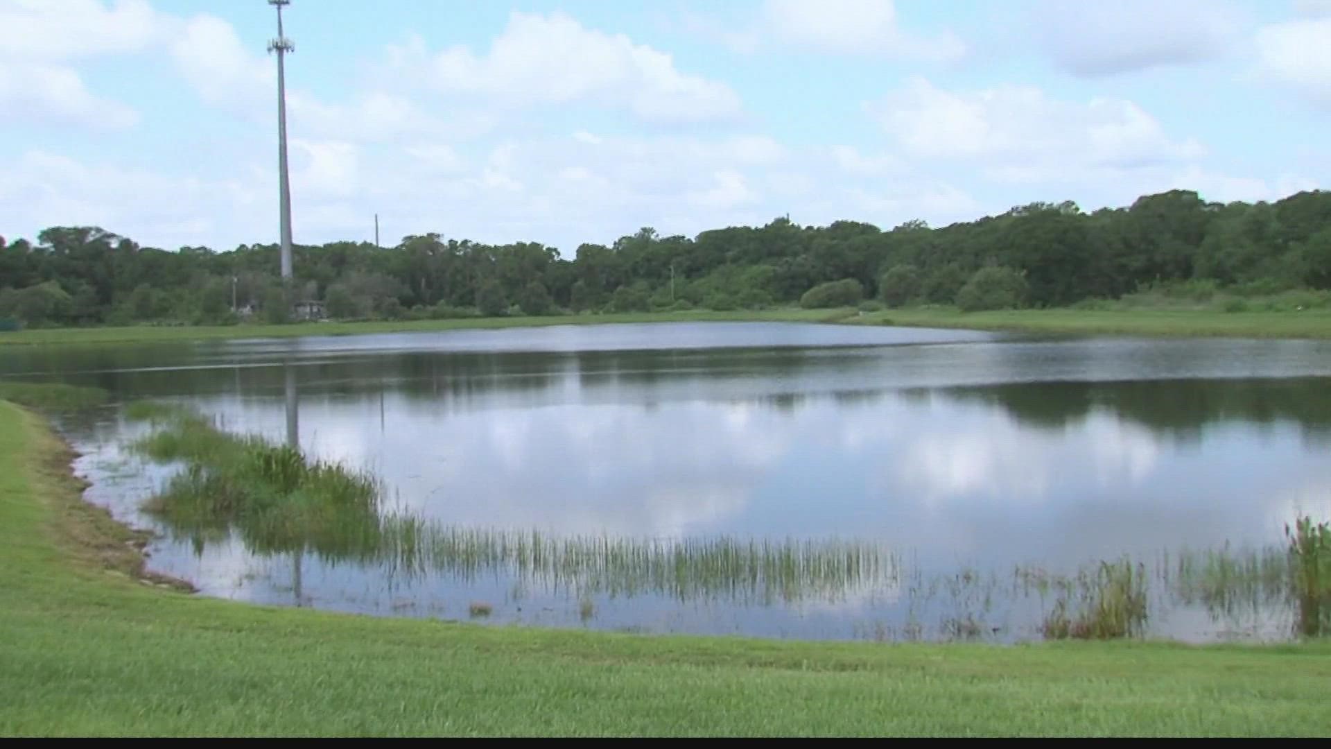 Man has close encounter with gator when grabbing a ball from water.