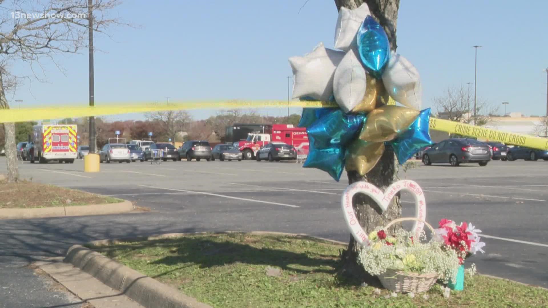 Community members in Chesapeake placed flowers, candles and balloons at a makeshift memorial to the victims of the Walmart mass shooting.